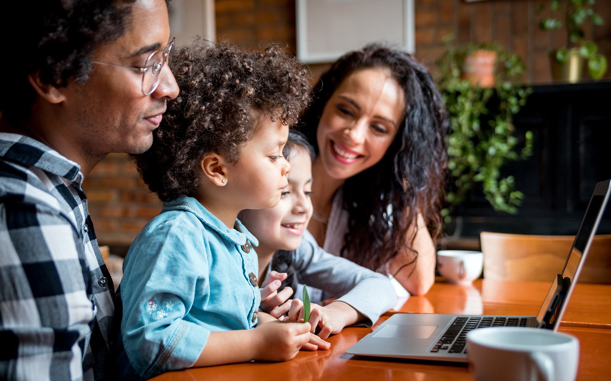 Family sharing moments on a home computer